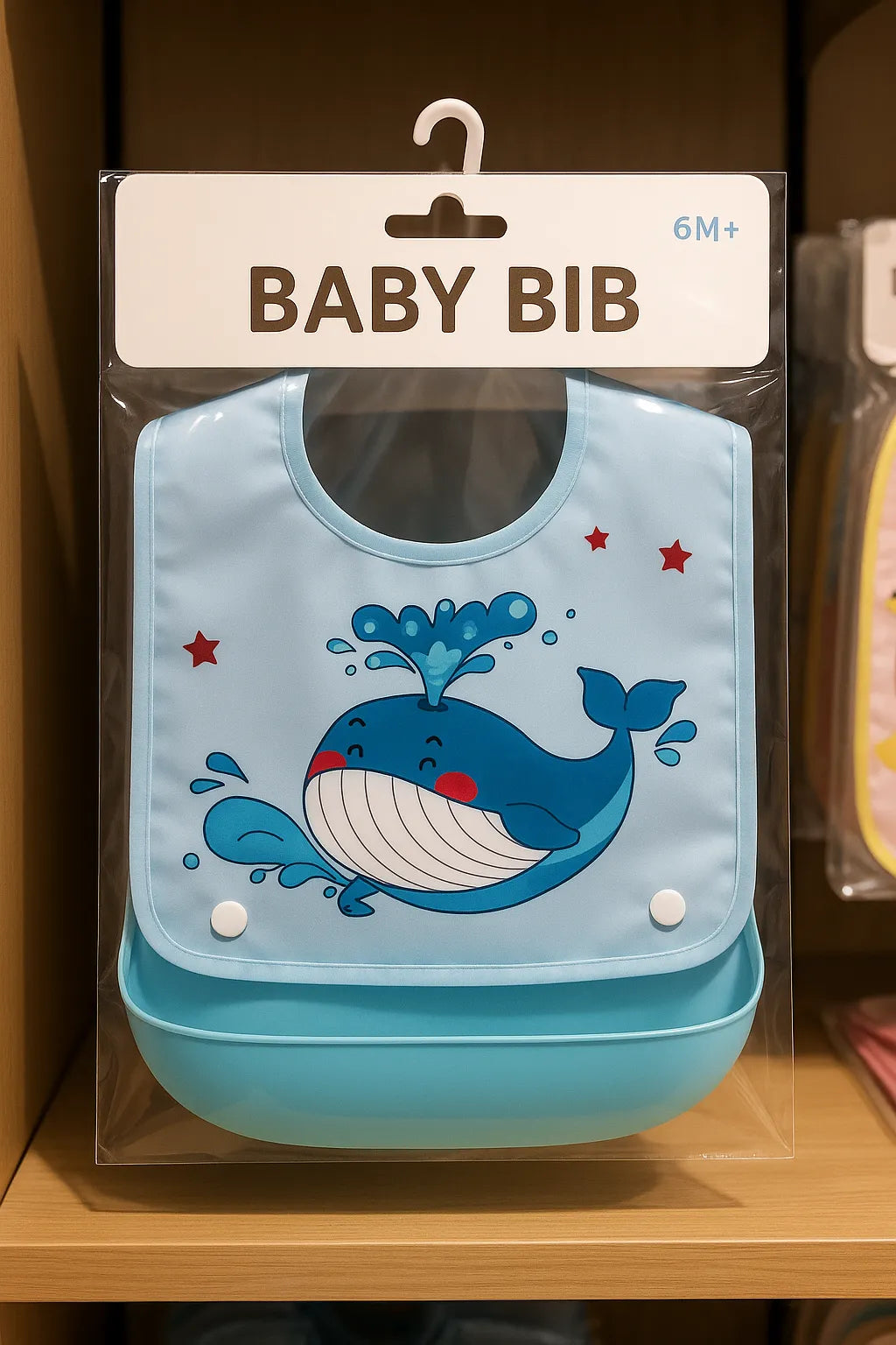 Baby bib with whale design in packaging on a shelf